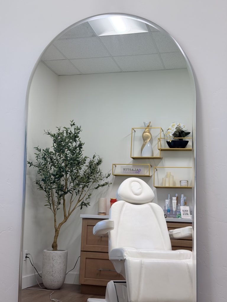 A bright treatment room with an arched mirror at Epiphany Clinic